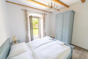 a bedroom with a bed and a window at Amalija Apartments in Strunjan