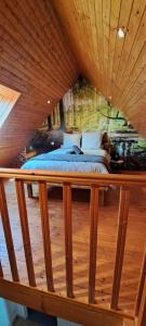 a bed in a room with a wooden ceiling at Cottage La loge in Huisnes-sur-Mer