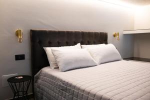 a bedroom with a bed with white pillows at BeTurin in Turin