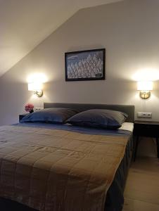 a bedroom with a bed and two lights on the wall at Appartment Schloss-Zeit in Aschau im Chiemgau