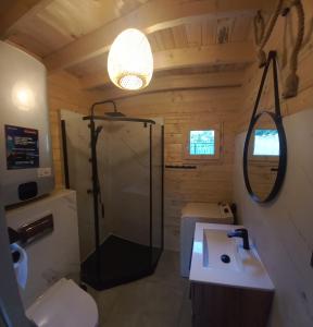 a bathroom with a shower and a sink at Warchały Lake House in Warchały