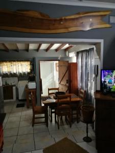a kitchen with a dining room table and chairs at Moeg Geploeg Lodge in Port Shepstone