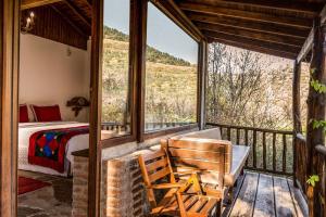 a bedroom with a bed and a large window at Stonehouse in Selçuk