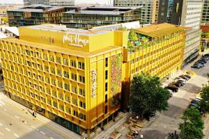 an overhead view of a yellow building in a city at Next House Copenhagen in Copenhagen