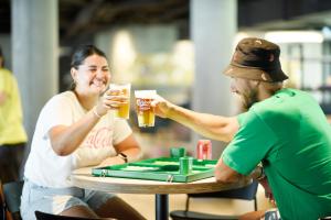 two people sitting at a table drinking beer at Next House Copenhagen in Copenhagen
