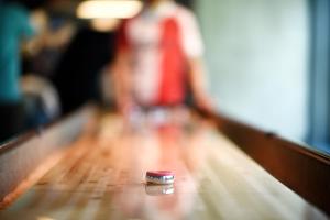 a ring sitting on a table in a bowling alley at Next House Copenhagen in Copenhagen