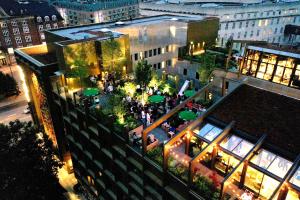 an overhead view of a building with a courtyard with umbrellas at Next House Copenhagen in Copenhagen
