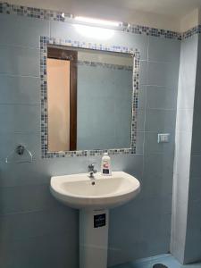 a bathroom with a sink and a mirror at La Dimora del RE in Gaeta