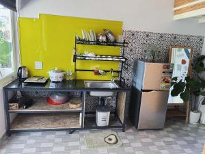 a kitchen with a sink and a refrigerator at Lem Homestay Đà Lạt in Da Lat