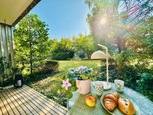 a table with a plate of bread and fruit on it at New, central studio with garden terrace and much privacy in Zurich