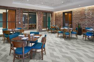 a restaurant with wooden tables and blue chairs at Residence Inn by Marriott Washington Downtown/Convention Center in Washington