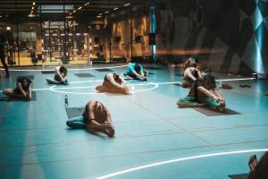 a group of people laying on the floor in a gym at Next House Copenhagen in Copenhagen