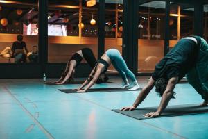 a group of people doing a yoga pose on the floor at Next House Copenhagen in Copenhagen