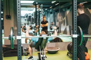 a group of people in a gym lifting weights at Next House Copenhagen in Copenhagen