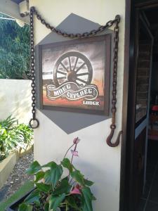 a picture of a wheel on the side of a building at Moeg Geploeg Lodge in Port Shepstone