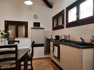 a kitchen with a table and a stove top oven at Via Zagarelli alle Mura 80 in Ravenna