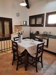 a kitchen with a table with a vase of flowers on it at Via Zagarelli alle Mura 80 in Ravenna +23 photos