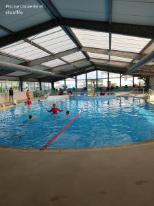 a large swimming pool with people in the water at davorel mobil home in Les Mathes