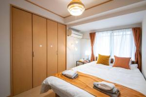 Postel nebo postele na pokoji v ubytování Rea新小岩2丁目403