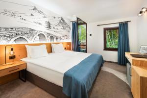 Uma cama ou camas num quarto em Hotel Alfaresort Thermal Chiflika