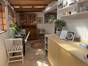 a kitchen with a counter and a table and a chair at Treetops Cottage in Cape Town