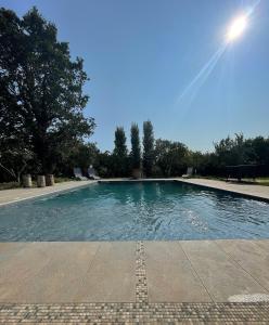 a large swimming pool with blue water at Nakupenda Relais in Latina