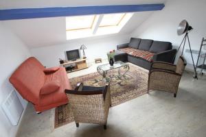 a living room with a couch and a table at DOMAINE DES GRAVIERS in Plainfaing