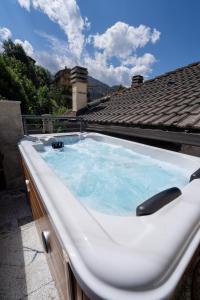 a hot tub sitting on top of a house at Le Suites de San Campel RTA in Ponte di Legno