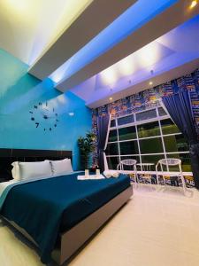 a blue bedroom with a bed and a window at Skeyndor Health & Resort in Na Jomtien