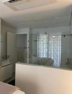 a white room with a mirror and a sink at Umhlanga Ocean Dunes in Umhlanga