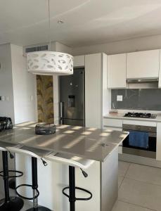 a kitchen with a large island in the middle at Umhlanga Ocean Dunes in Umhlanga