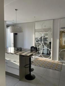 a kitchen with a table and a dining room at Umhlanga Ocean Dunes in Umhlanga