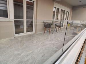 a patio with a table and chairs on a house at Luxury Apartments Deskati A1 