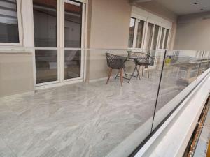 a patio with a table and chairs on a house at Luxury Apartments Deskati A1 in Deskáti