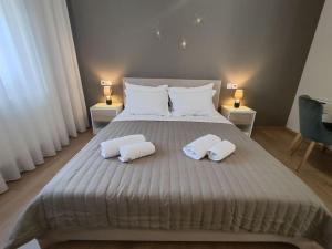 a bedroom with a large bed with two white pillows at Luxury Apartments Deskati A1 