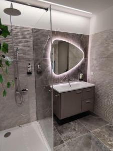 a bathroom with a sink and a shower with a mirror at Luxury Apartments Deskati A1 