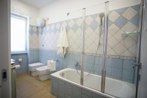 a bathroom with a shower and a tub and a toilet at StabiaHome City and Sea in Castellammare di Stabia