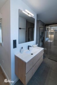 a bathroom with a sink and a mirror and a shower at La Iaia Maria in Gandía +20 photos