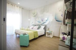 a bedroom with a bed with a green suitcase at StabiaHome City and Sea in Castellammare di Stabia