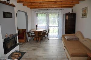 a living room with a table and chairs and a couch at Agroturystyka u Hani in Wola Niżna
