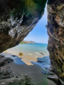 a view of a beach from inside a cave at Livikon Studios & Rooms in Rodakino