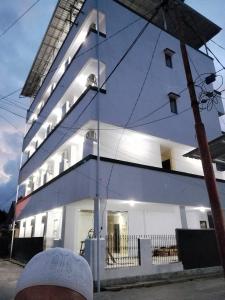 a large white building with lights on it at Maluku Residence Syariah in Ambon +17 photos