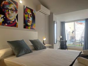 a bedroom with a bed with a painting on the wall at BET Apartments - Central Market Apartments in Valencia