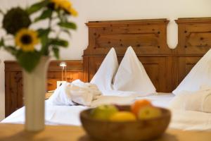 A bed or beds in a room at Dolomitenhotel Weisslahnbad