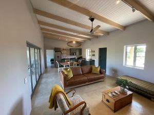 uma sala de estar com um sofá e uma mesa em Windon vineyard farmhouse em Stellenbosch