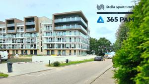 a building on the side of a street with a parking lot at Hawaje apartament przy plaży - 365PAM in Sianozety