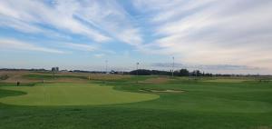 a green golf course with people playing on the greens at Victoria Garden in Tarnowo Podgórne
