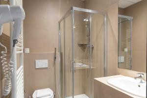 a bathroom with a shower and a toilet and a sink at Plus Florence in Florence