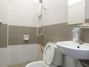 a bathroom with a toilet and a sink at Bushra Guest House, Batu Pahat in Batu Pahat