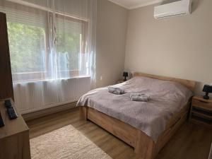 Posteľ alebo postele v izbe v ubytovaní Tulipán Apartman